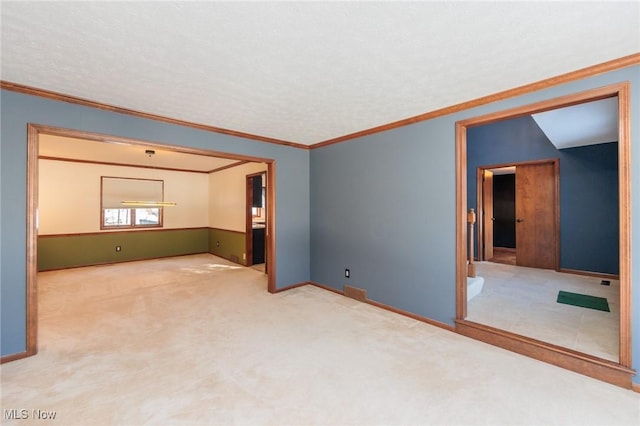 carpeted empty room featuring crown molding