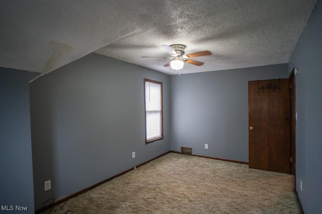 bonus room with a textured ceiling, light colored carpet, and ceiling fan