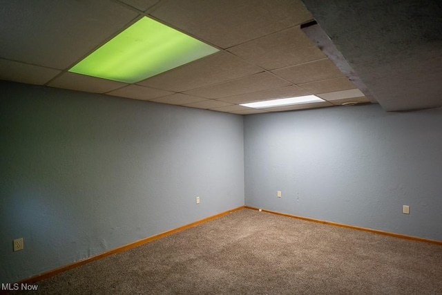 unfurnished room with carpet floors and a drop ceiling