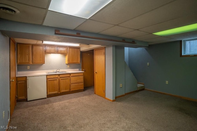 kitchen with sink, light colored carpet, dishwashing machine, and a drop ceiling