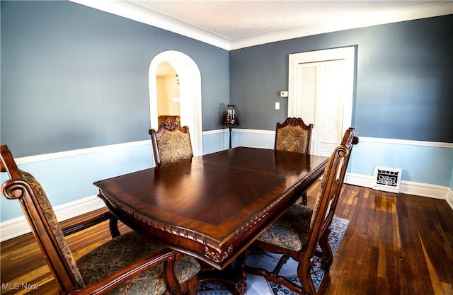 dining area featuring hardwood / wood-style flooring and crown molding