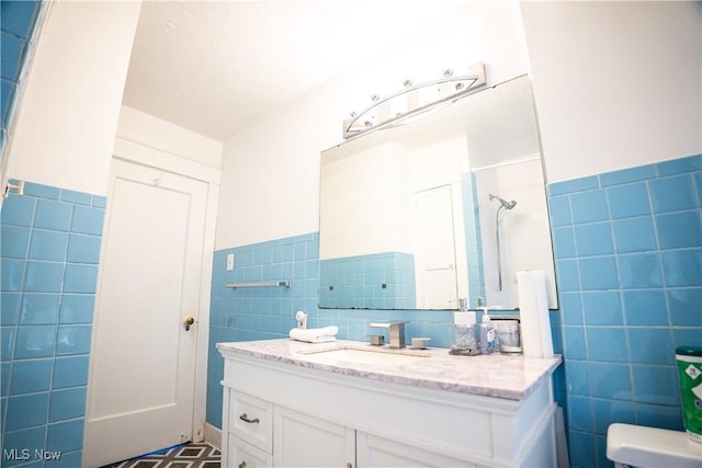 bathroom with vanity and tile walls