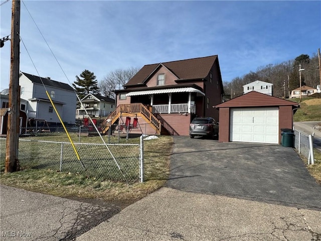 view of front of property featuring a garage and an outdoor structure