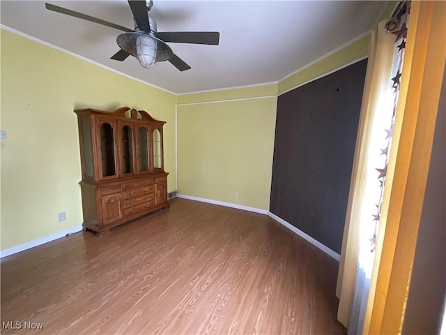 spare room featuring ornamental molding, hardwood / wood-style floors, and ceiling fan