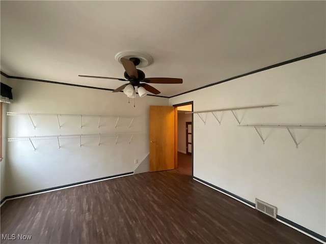 unfurnished room with ceiling fan and dark hardwood / wood-style flooring