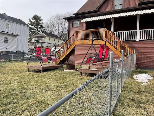 view of play area with a wooden deck and a yard