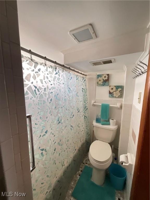 bathroom with a shower with curtain and toilet