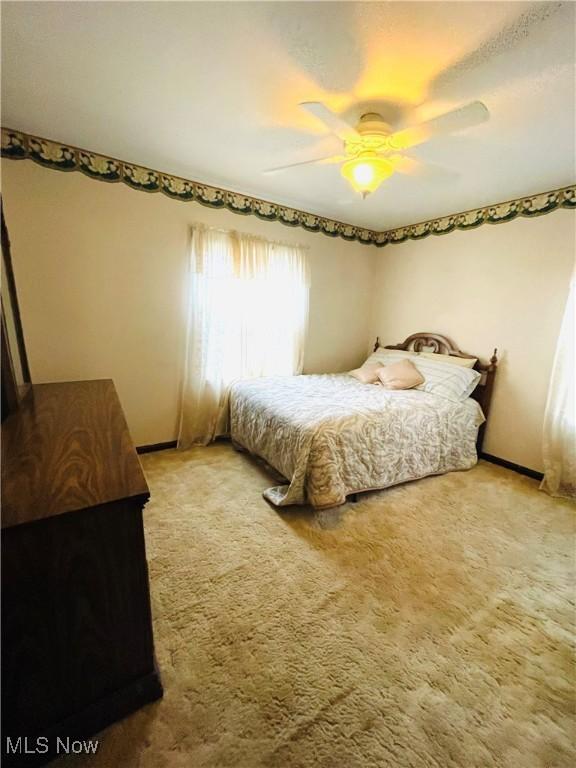 carpeted bedroom featuring ceiling fan