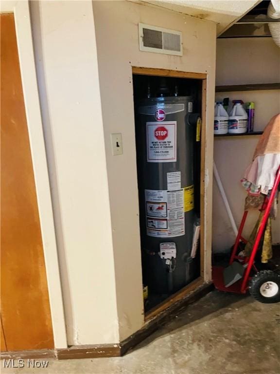 utility room featuring water heater