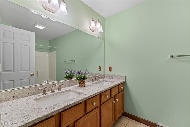 bathroom featuring vanity, a baseboard radiator, tile patterned floors, and a shower