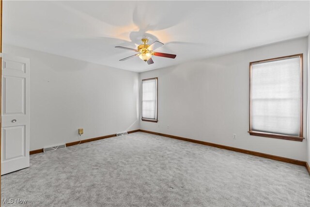 carpeted empty room featuring ceiling fan