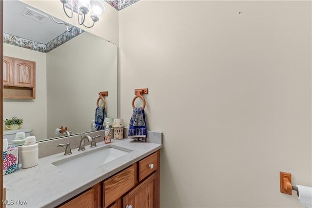 5420 Cloisters Dr, Canfield, OH 44406 - bathroom featuring a chandelier and vanity
