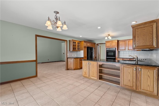 kitchen featuring decorative light fixtures, sink, dark stone countertops, decorative backsplash, and black appliances