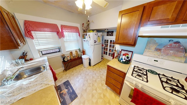 kitchen featuring ceiling fan, white appliances, and sink