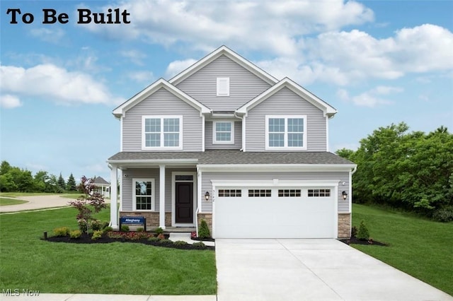 craftsman house featuring a garage and a front lawn