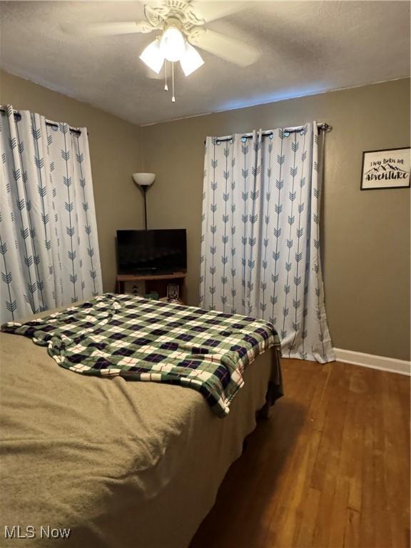 bedroom featuring dark hardwood / wood-style floors and ceiling fan