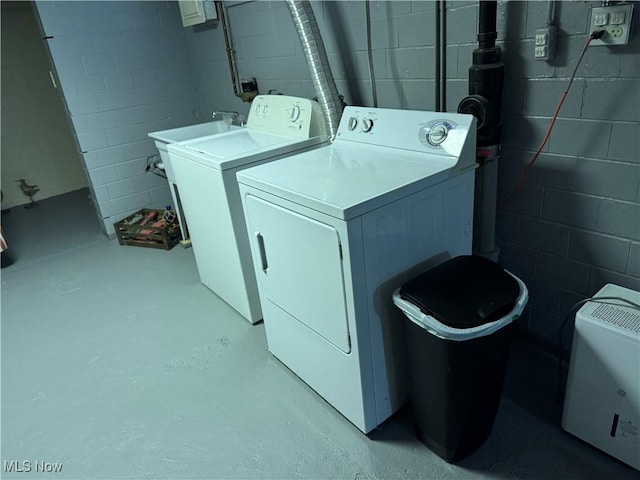 clothes washing area with washer and clothes dryer