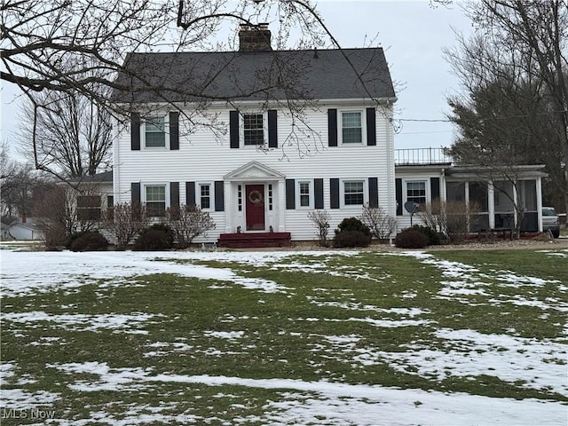 colonial-style house with a lawn