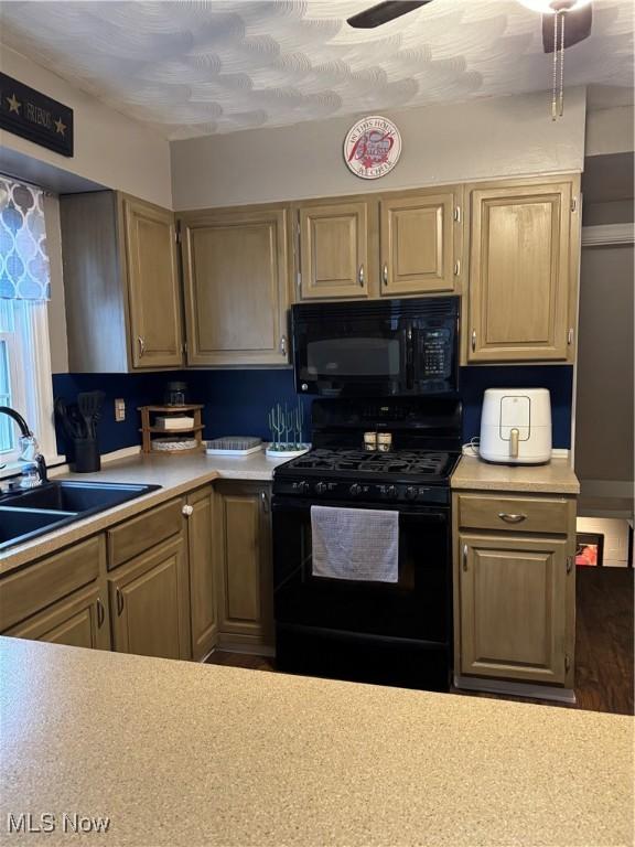 kitchen featuring sink, ceiling fan, and black appliances