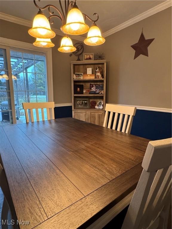 dining area featuring crown molding