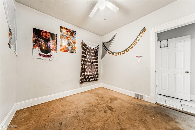 spare room featuring ceiling fan and carpet flooring