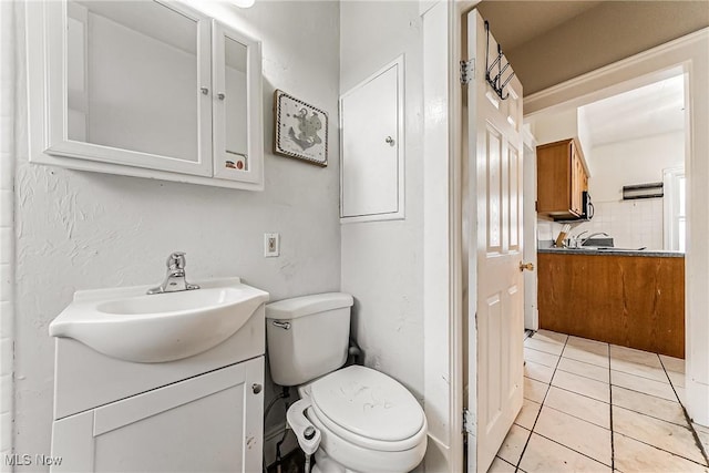 bathroom with decorative backsplash, vanity, tile patterned floors, and toilet