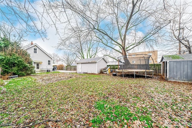 view of yard with a trampoline and a storage shed