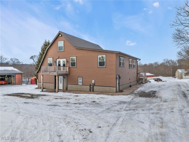 view of snow covered rear of property