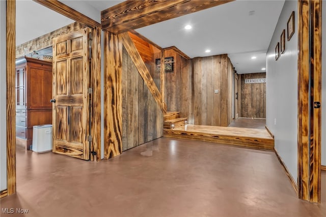 basement featuring wood walls