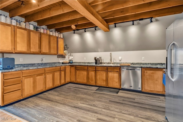 kitchen with appliances with stainless steel finishes, dark hardwood / wood-style floors, beamed ceiling, sink, and wooden ceiling