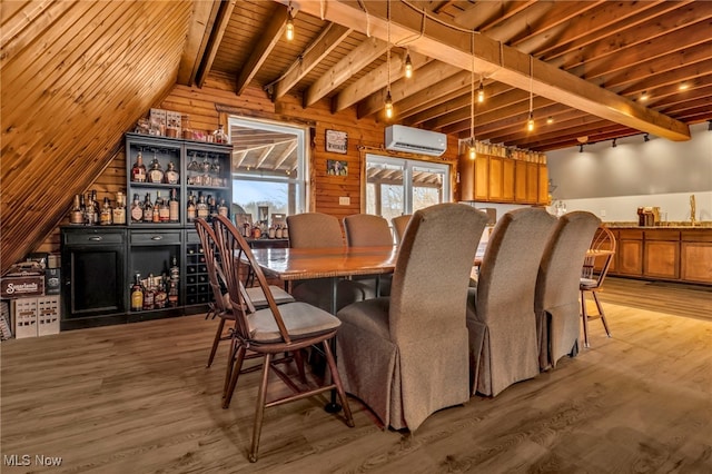 dining room featuring wood-type flooring, an AC wall unit, and beam ceiling