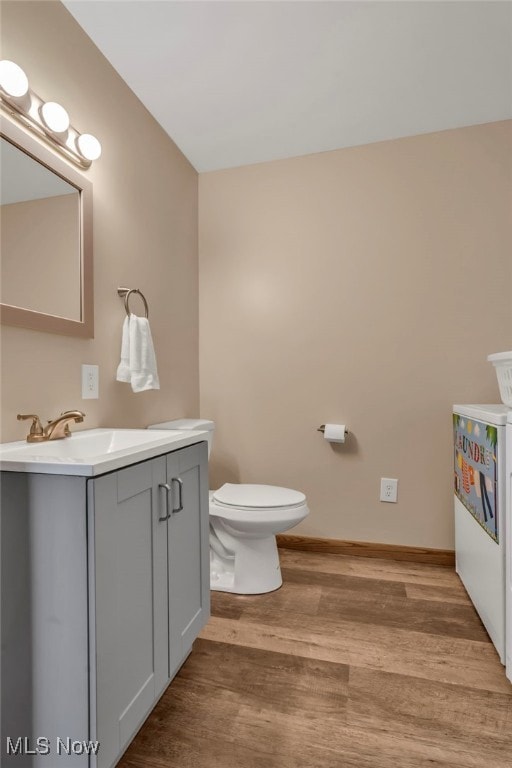 bathroom with vanity, hardwood / wood-style floors, and toilet