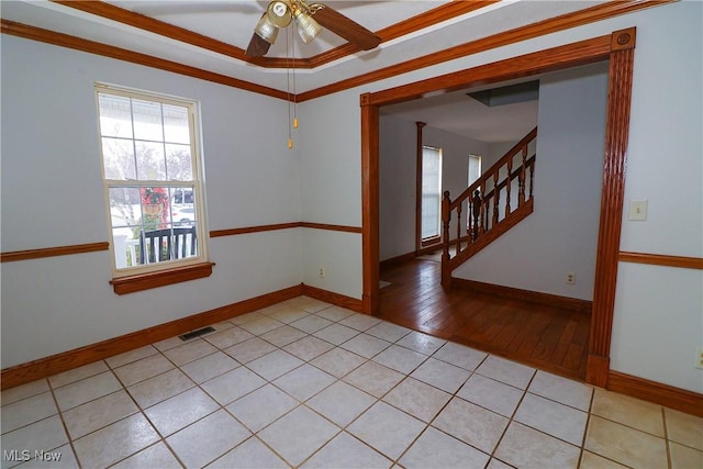 unfurnished room with crown molding, ceiling fan, and light tile patterned floors