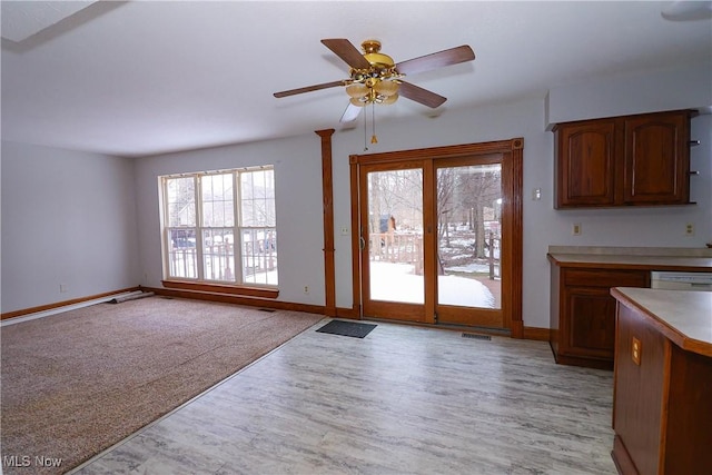 interior space featuring ceiling fan, white dishwasher, and light hardwood / wood-style floors