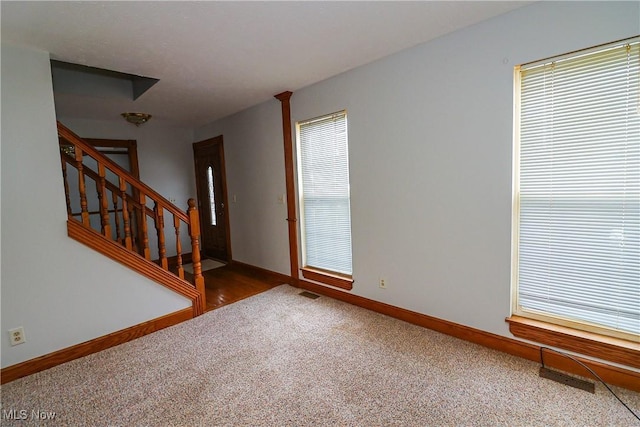 carpeted entrance foyer featuring plenty of natural light