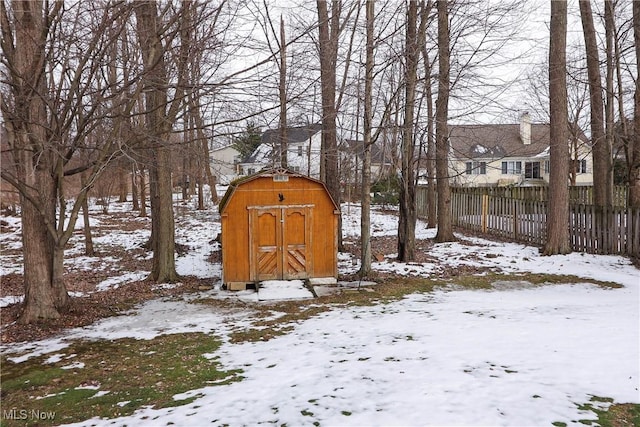 yard covered in snow with a shed