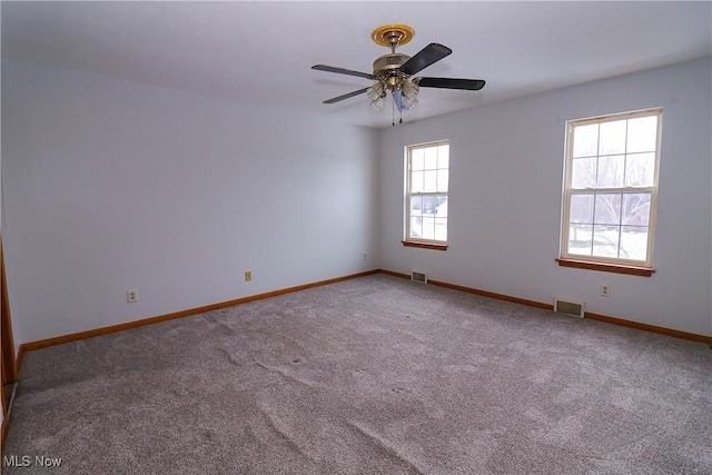 carpeted spare room with ceiling fan