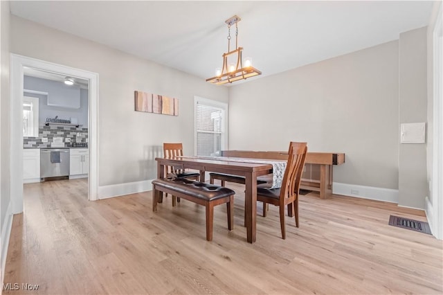 dining room with a chandelier and light hardwood / wood-style floors