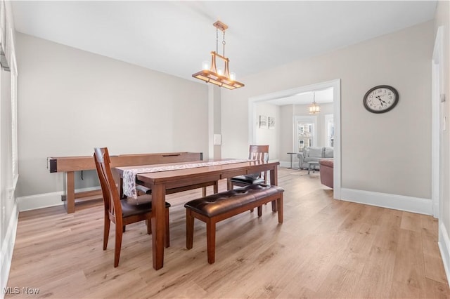 dining space with light hardwood / wood-style flooring