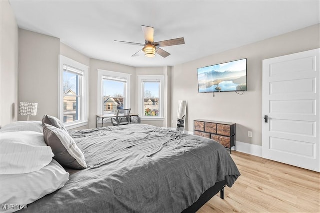 bedroom with ceiling fan and light hardwood / wood-style floors