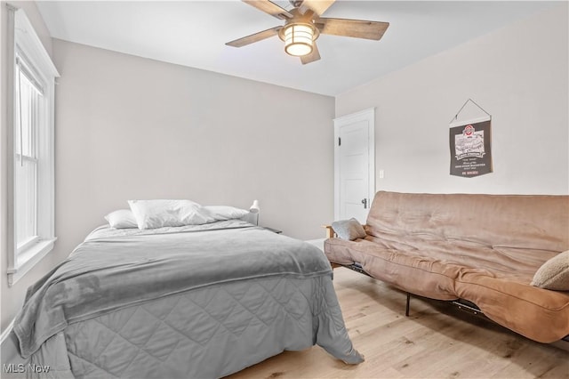 bedroom with ceiling fan and light wood-type flooring