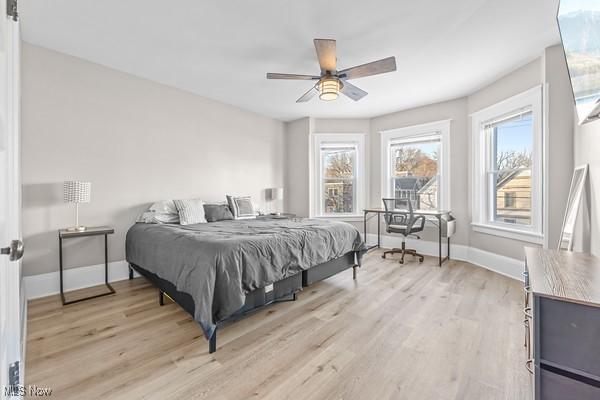 bedroom with ceiling fan and light hardwood / wood-style floors