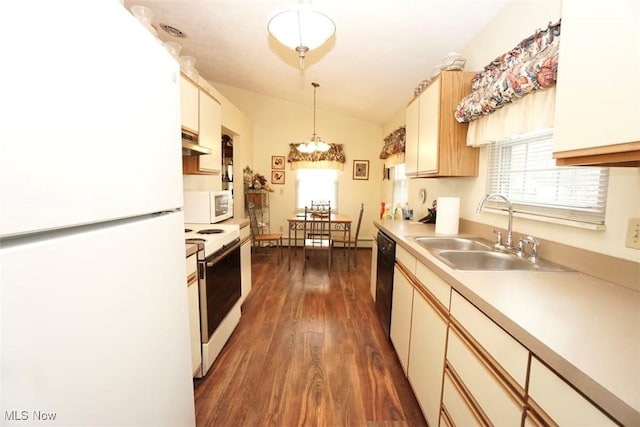 kitchen featuring sink, white appliances, dark wood-type flooring, hanging light fixtures, and vaulted ceiling