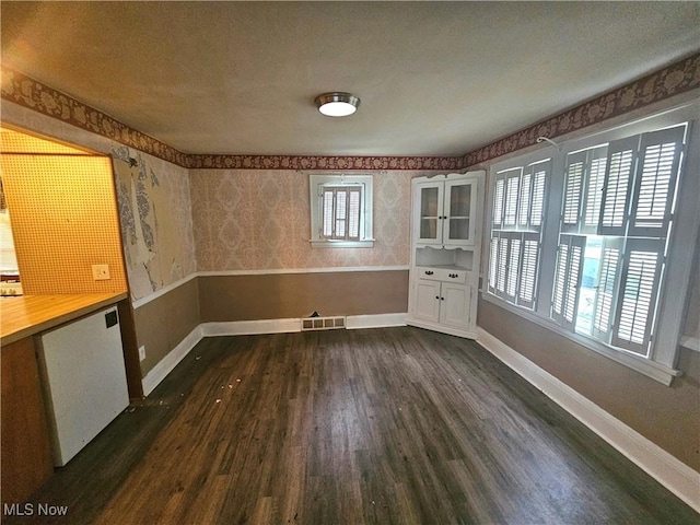 empty room with dark wood-type flooring