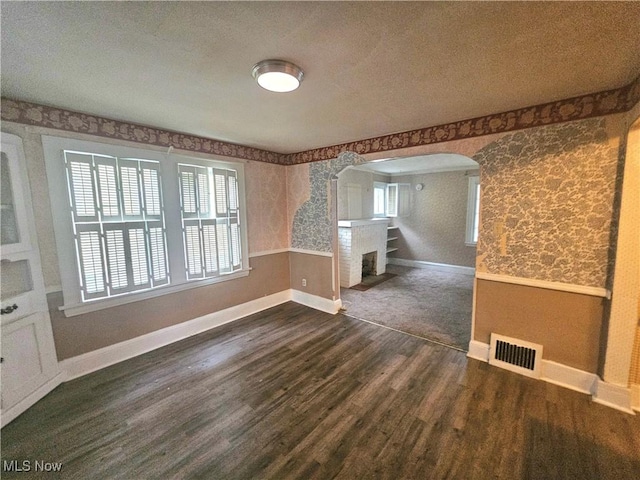 interior space featuring dark hardwood / wood-style floors and a textured ceiling