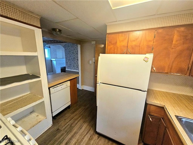 kitchen with dark wood-type flooring, sink, and white appliances