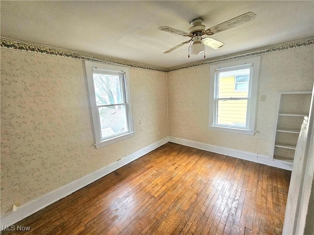 spare room with hardwood / wood-style flooring and ceiling fan