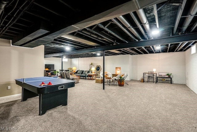 recreation room with brick wall and carpet