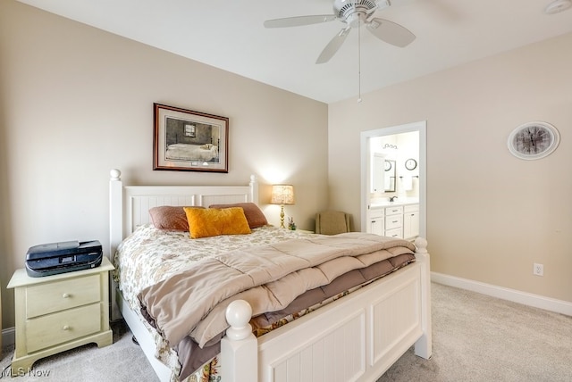 bedroom featuring connected bathroom, light colored carpet, and ceiling fan