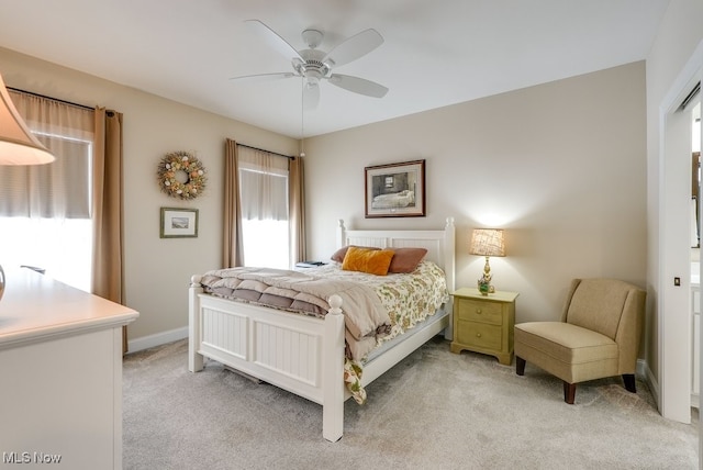 bedroom with ceiling fan and light carpet